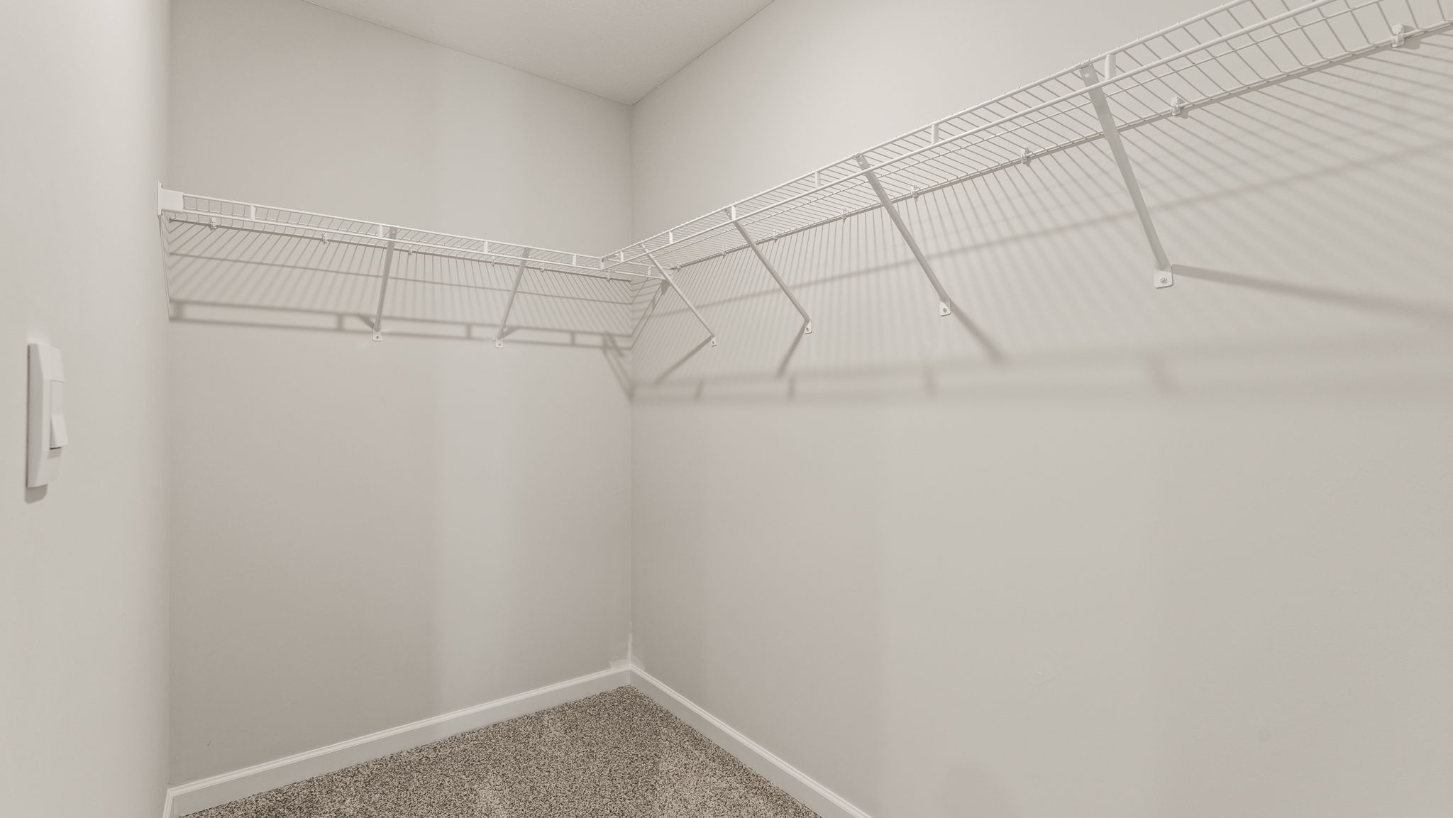 Walk-in closet with wire rack shelving.