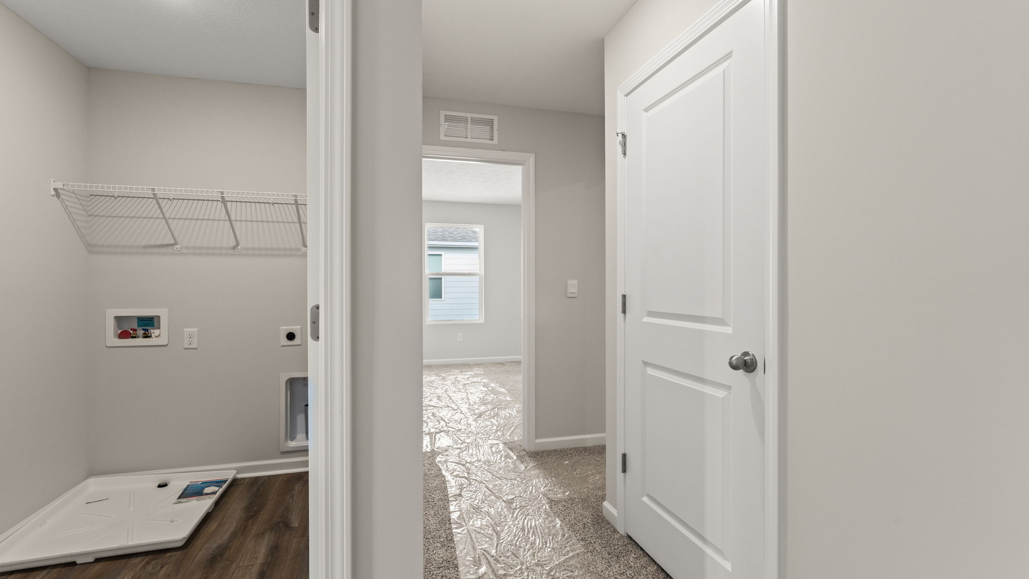 Image of wall dividing the laundry area and a bedroom