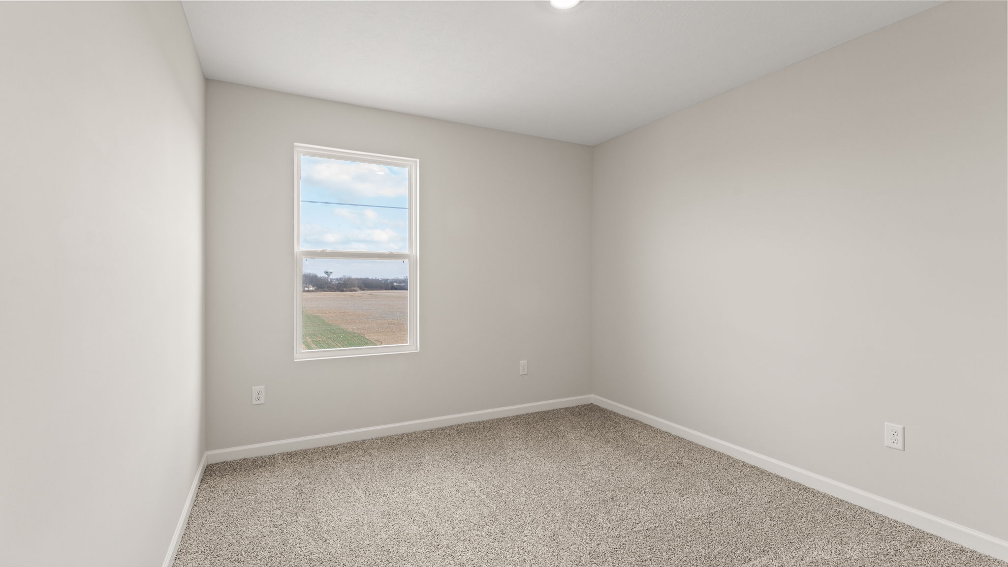 Carpeted bedroom with window