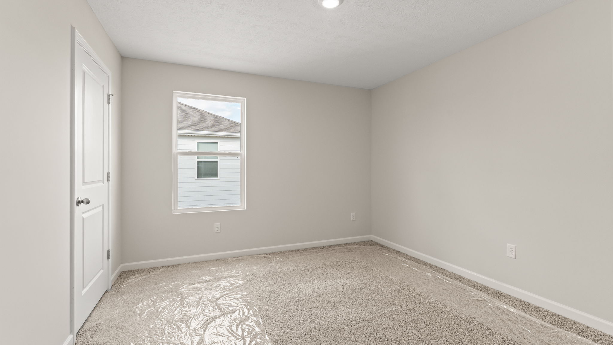 Carpeted bedroom with window