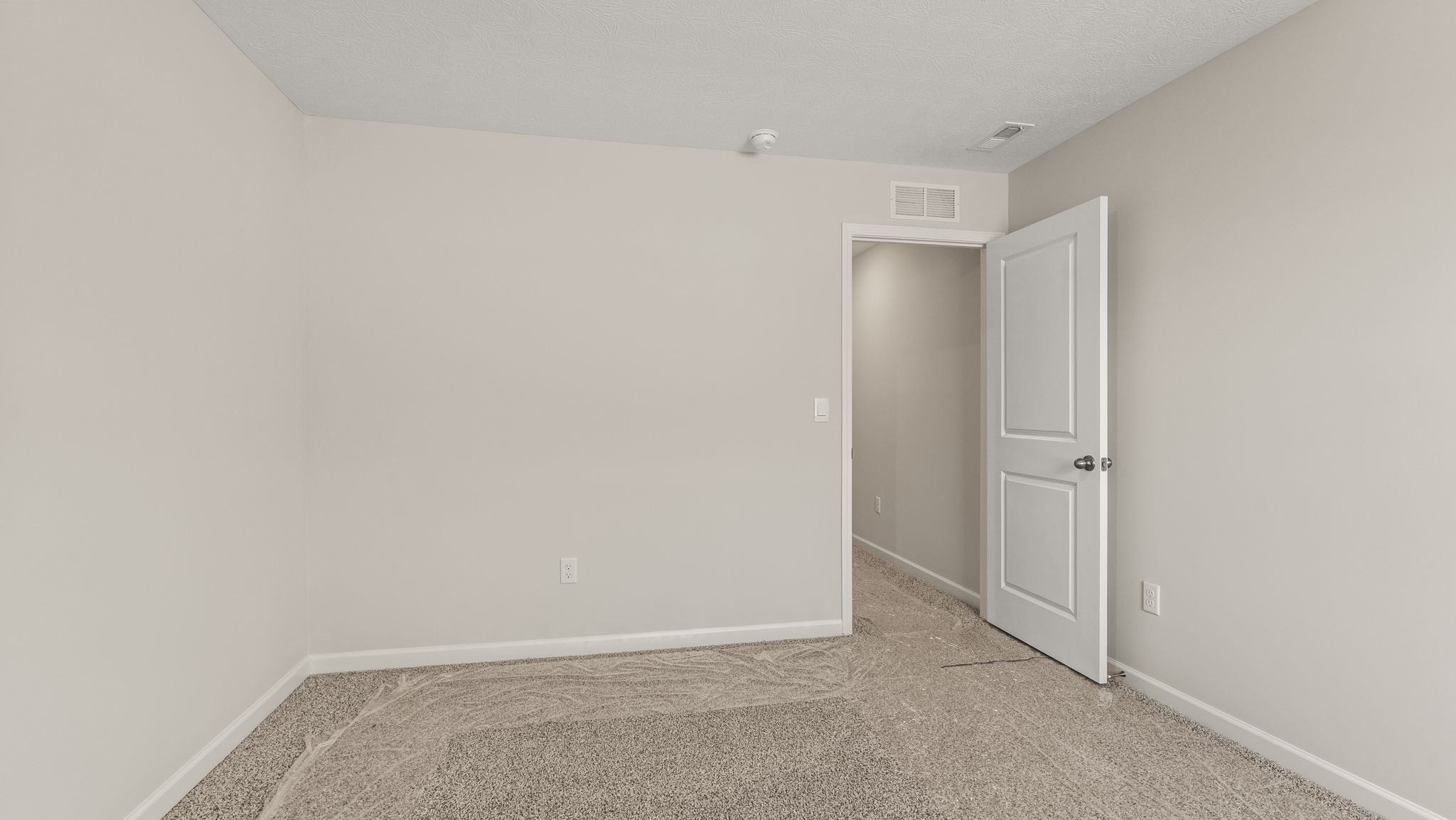 Carpeted bedroom with window