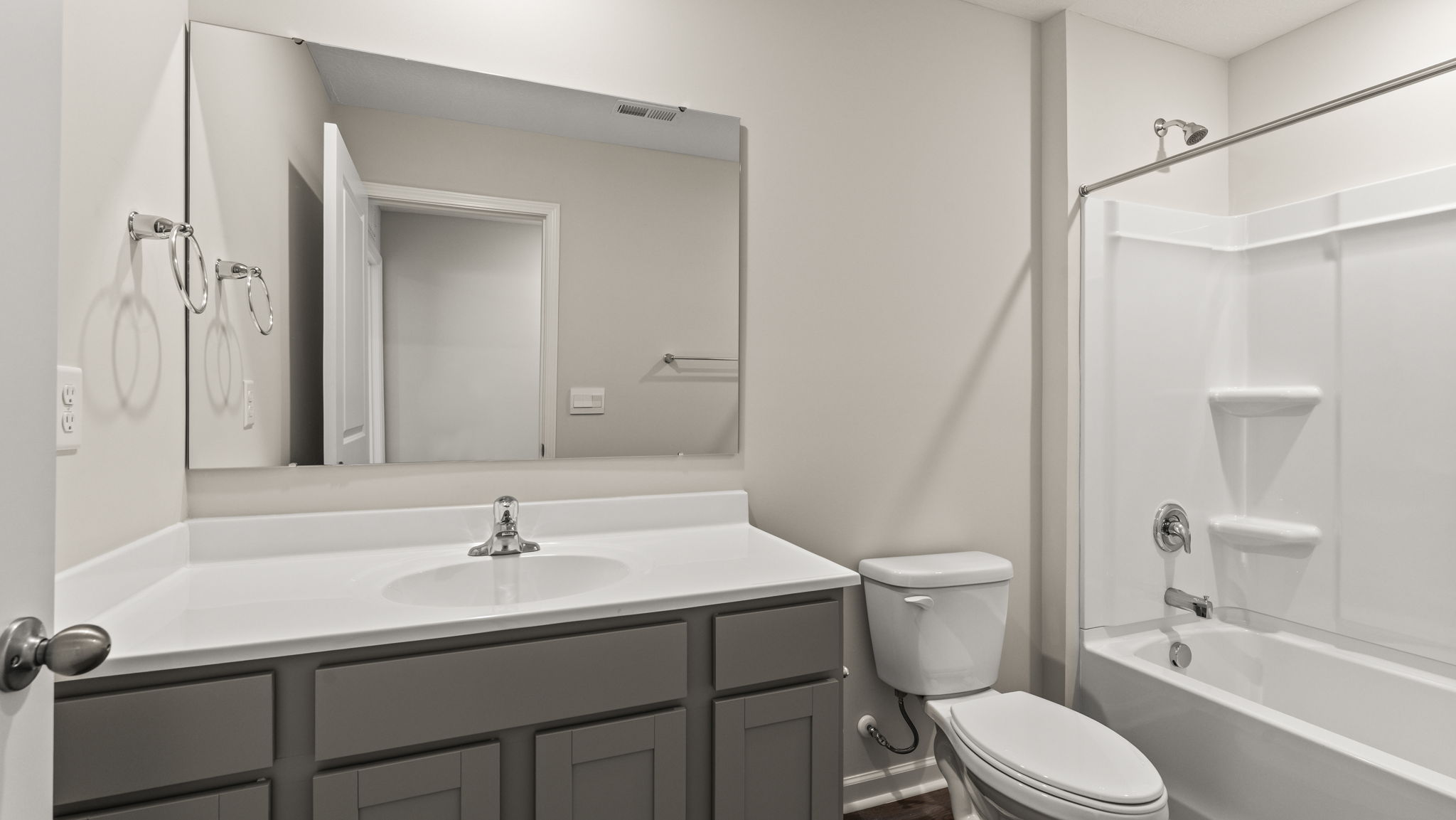 Upstairs bathroom with vanity, toilet, and tub.