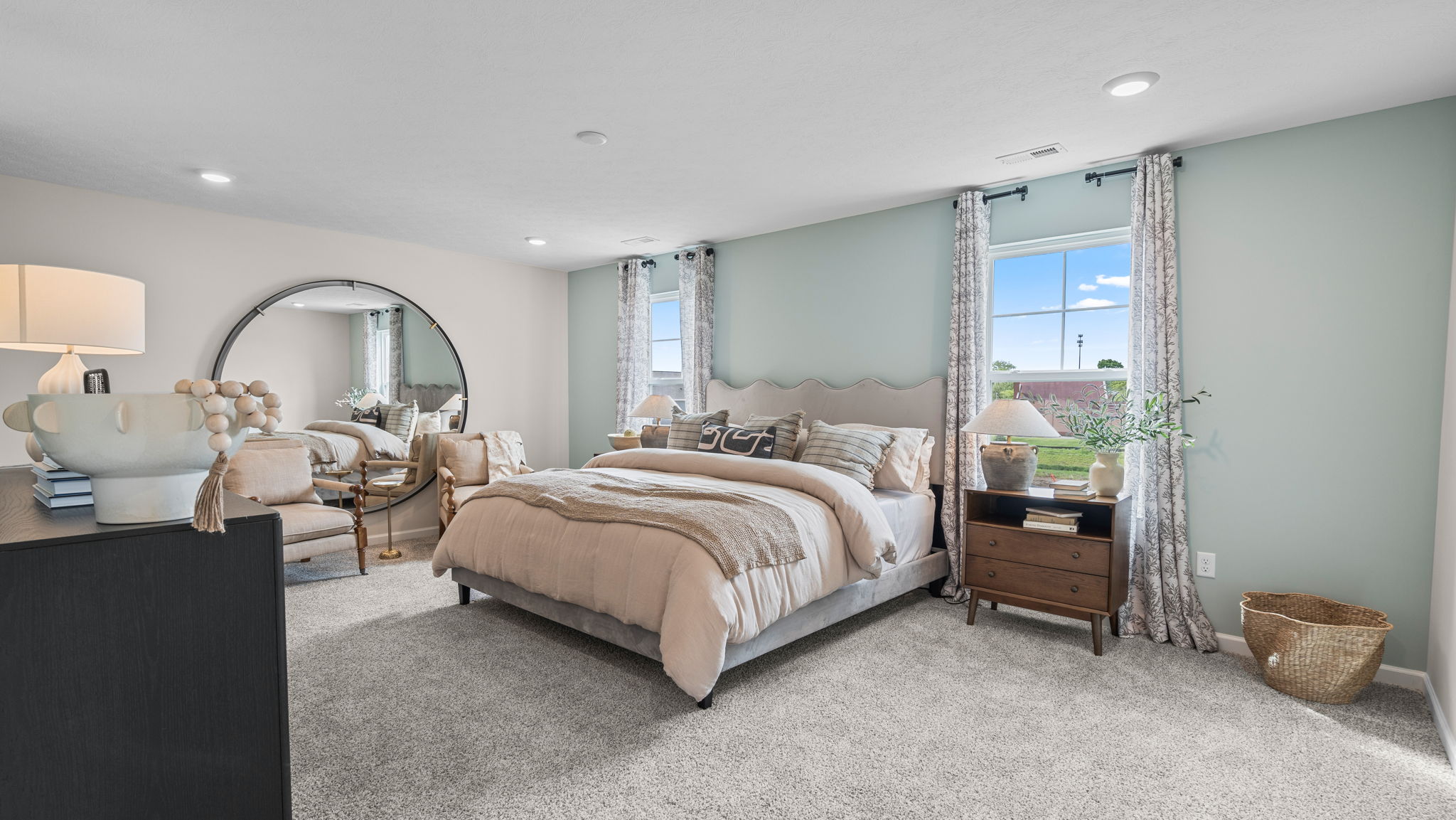 Primary bedroom with carpeted floors.