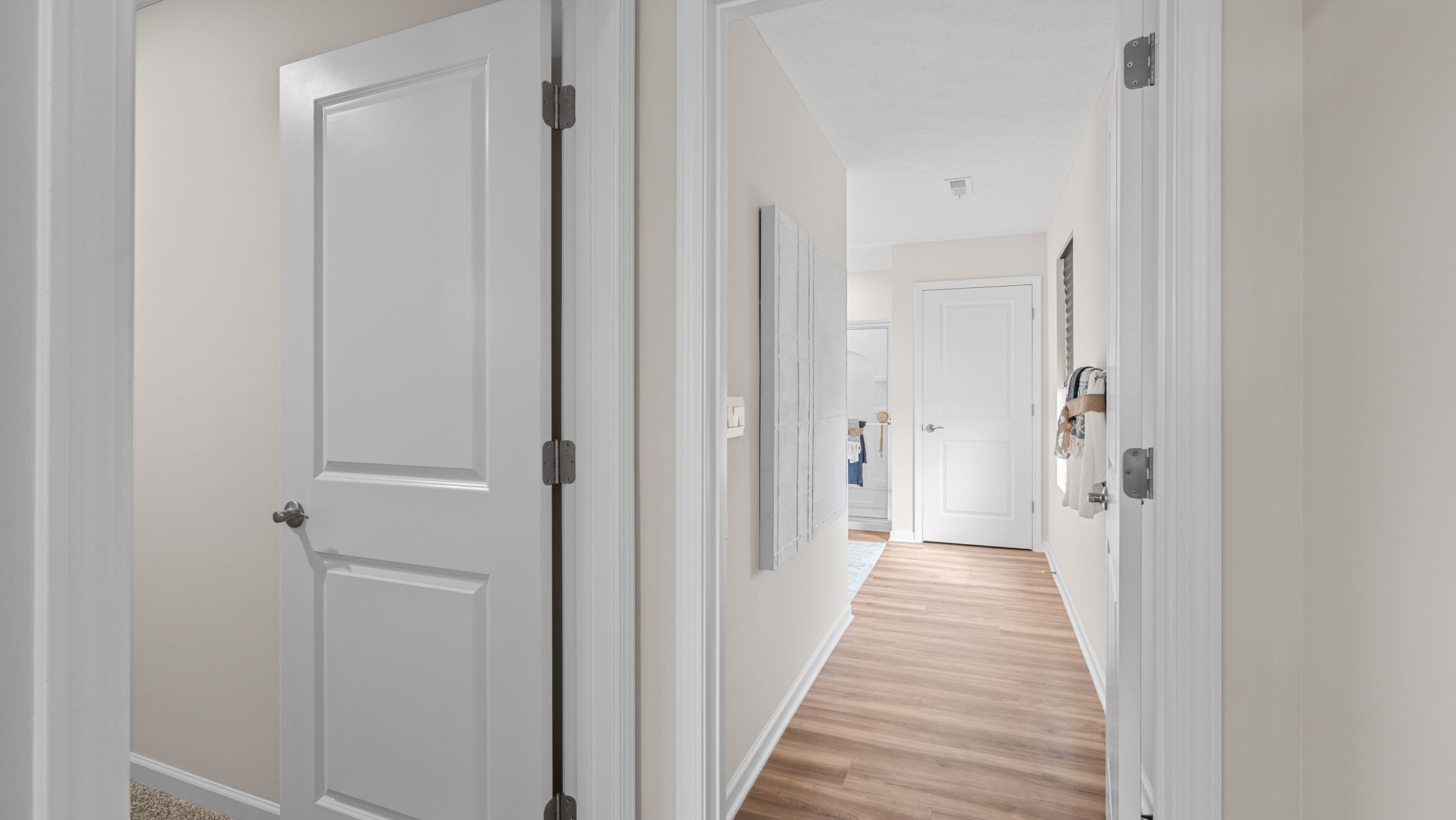 Primary bedroom with large carpeted walk in closet.