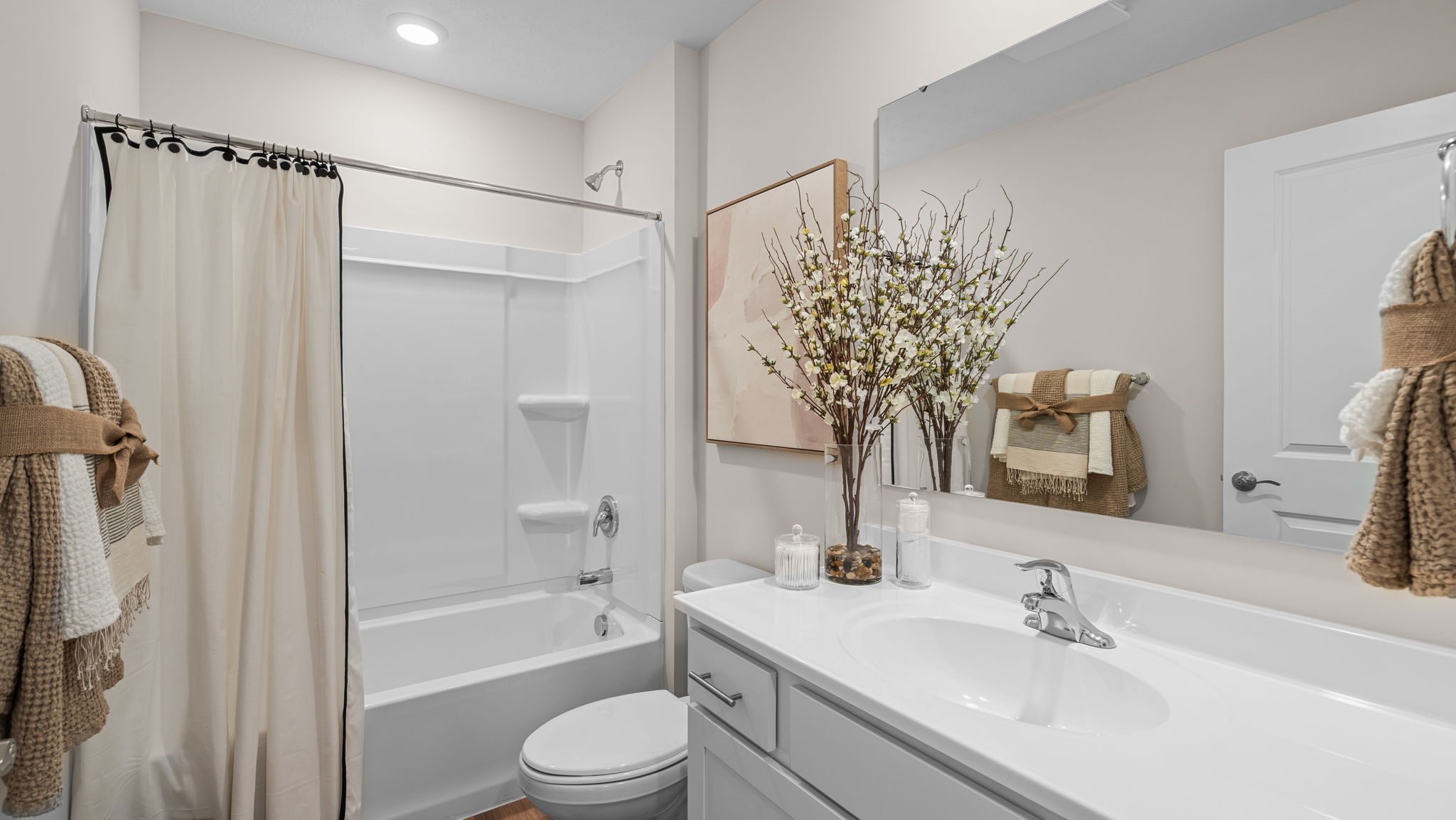 Bathroom with single sink and step in shower.