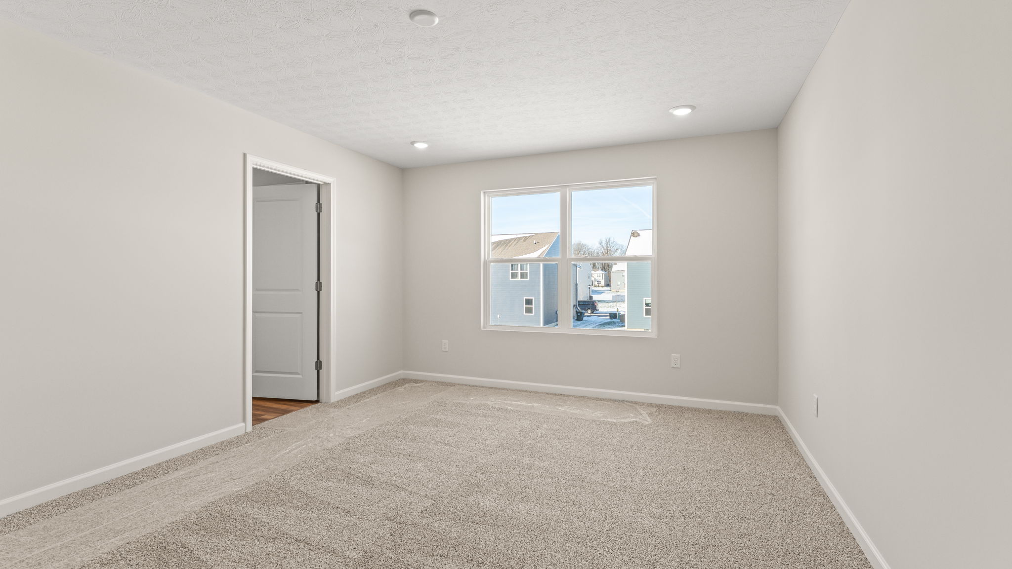 Primary bedroom with door to primary bathroom