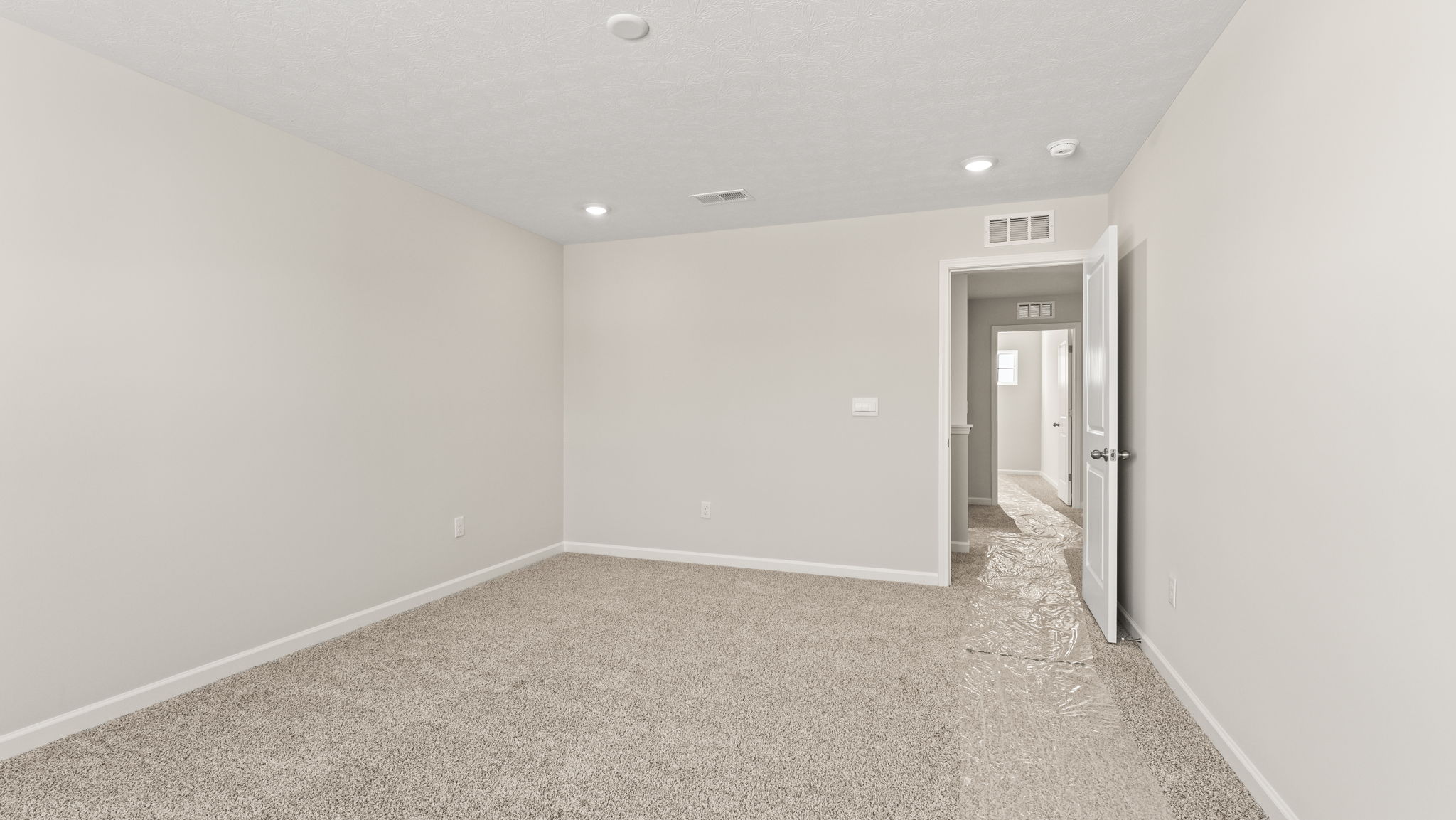 Primary bedroom with view of second floor hallway