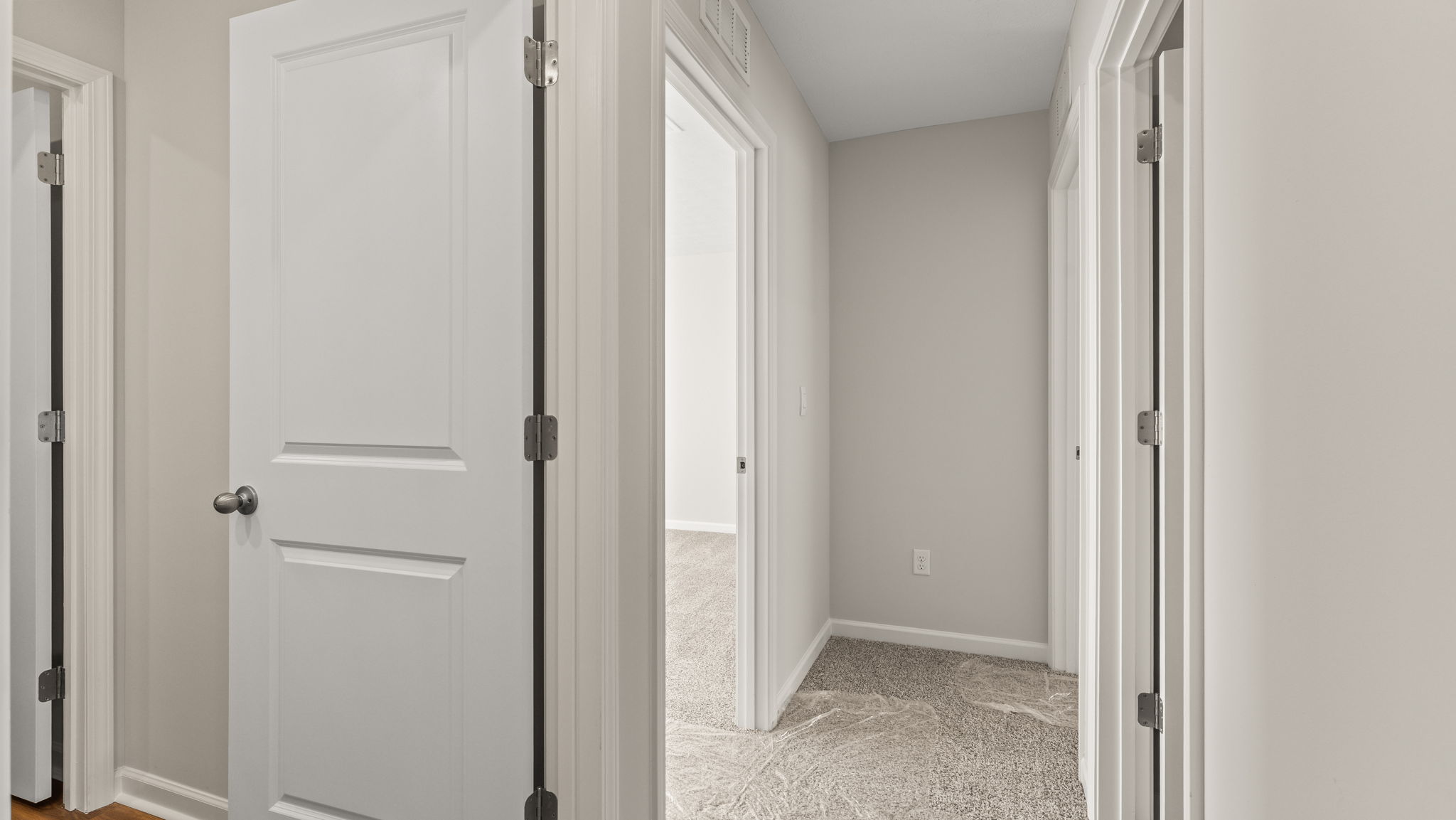 Hallway looking into storage and bedroom