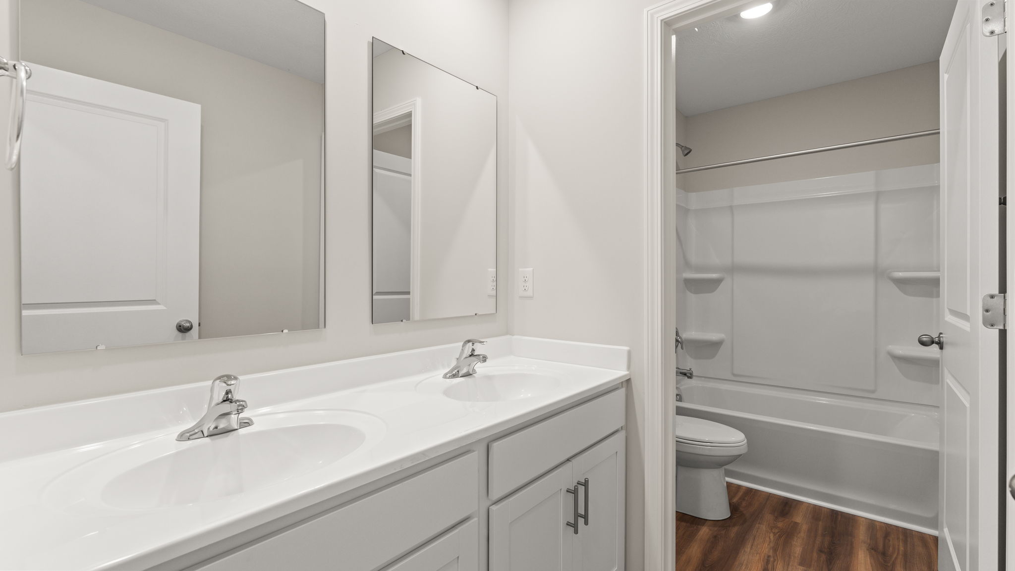 Second floor bathroom with vanity, mirror, and walk-in closet