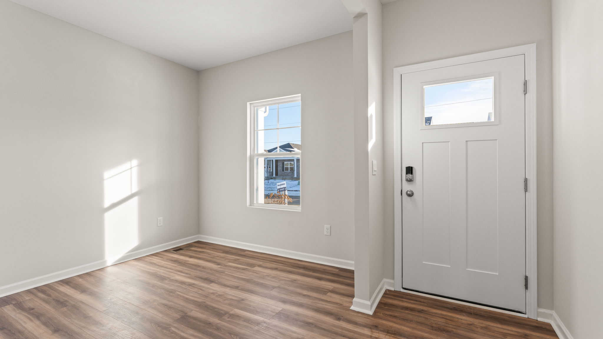 Front door of the home with a flex room to the side