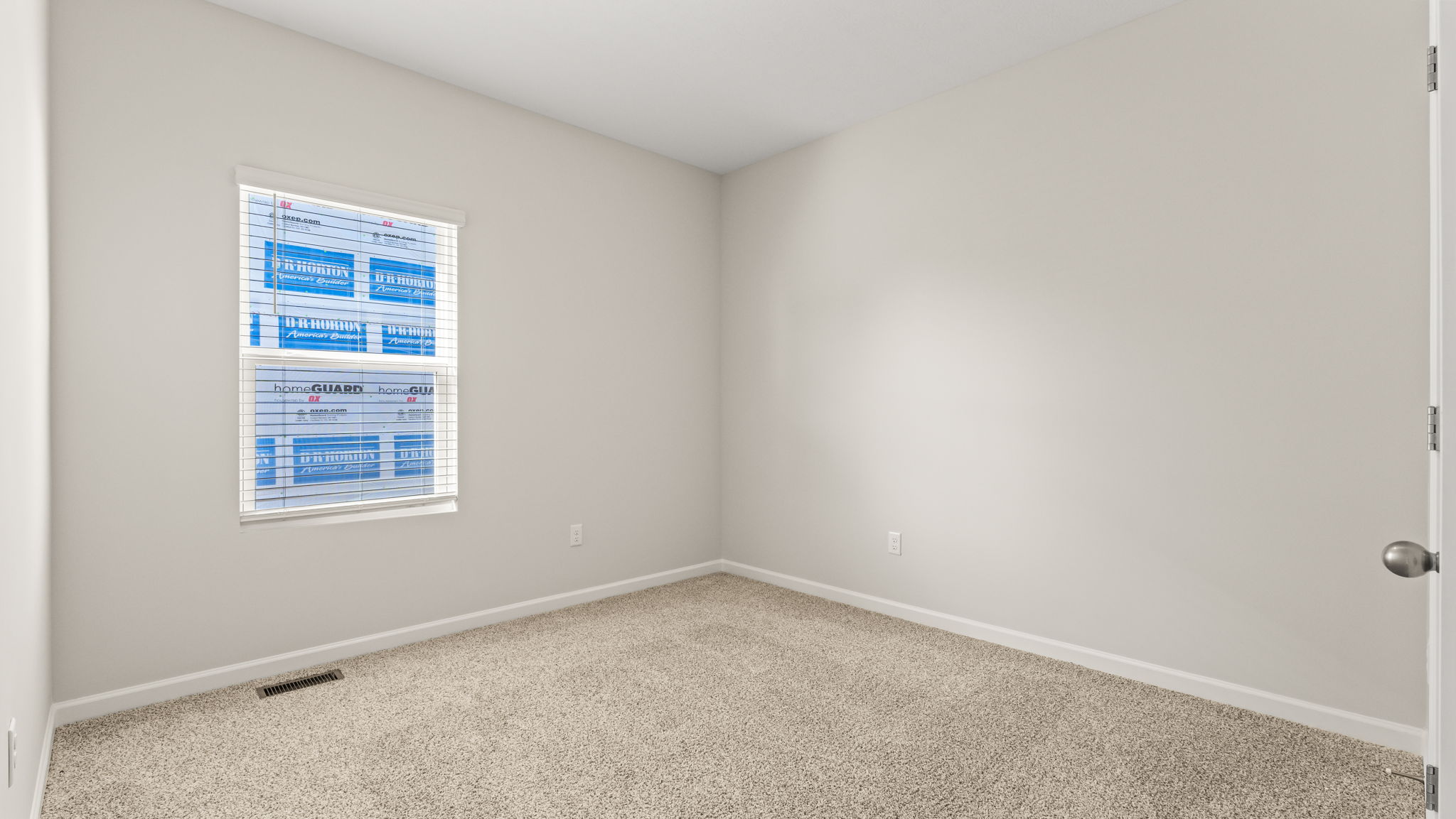 Carpeted bedroom with window