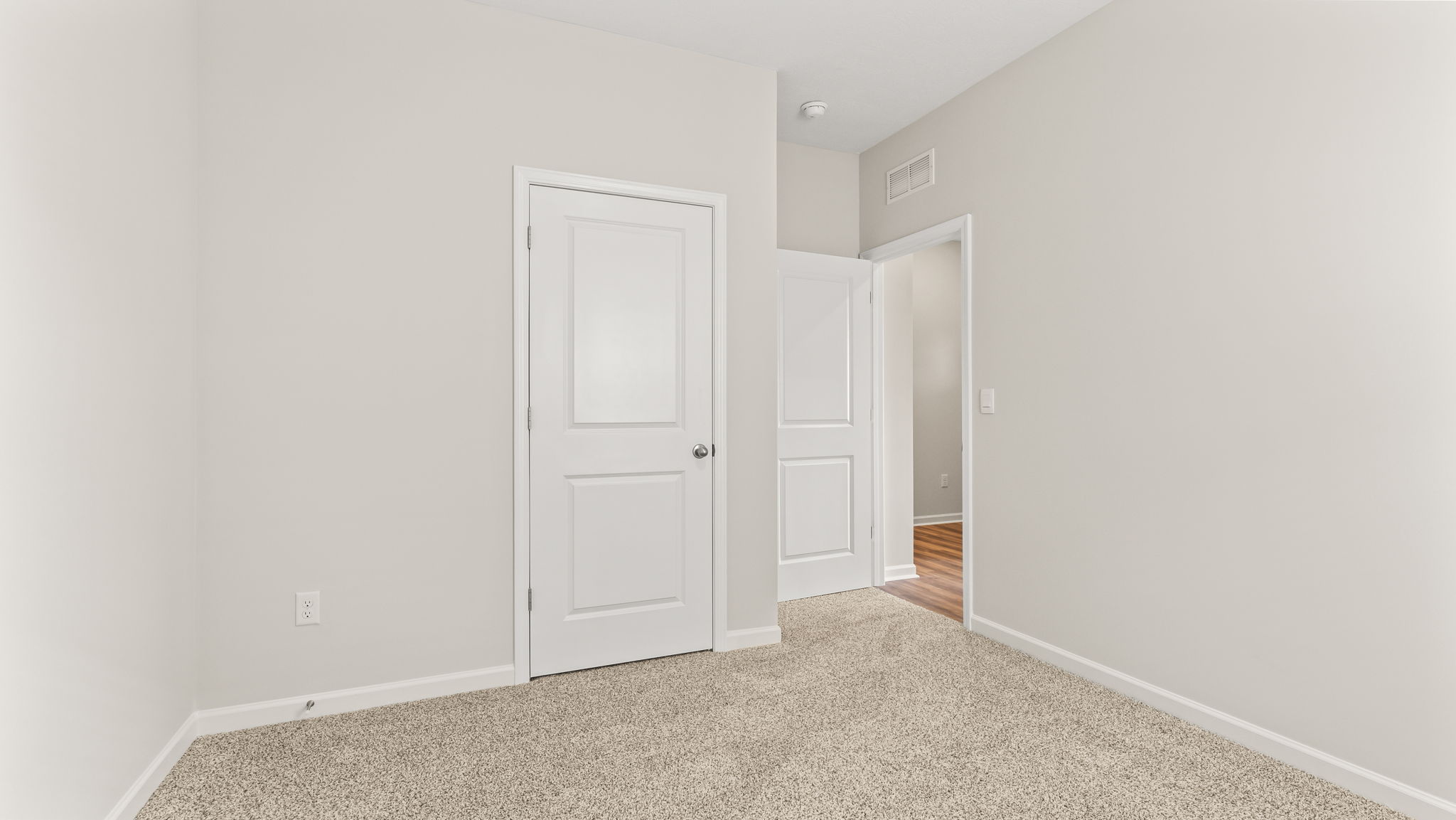 Carpeted bedroom with closet