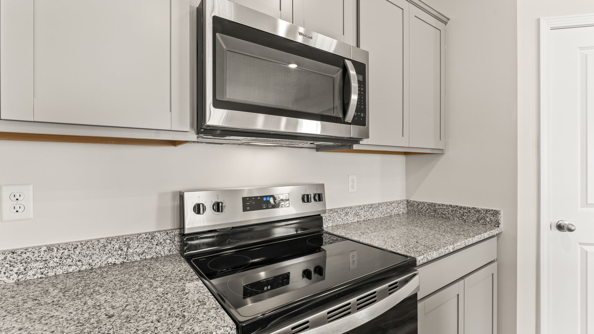 Closeup of oven range between granite countertops
