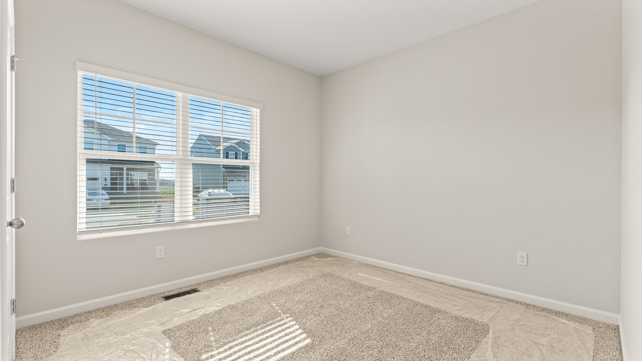 Carpeted bedroom with window