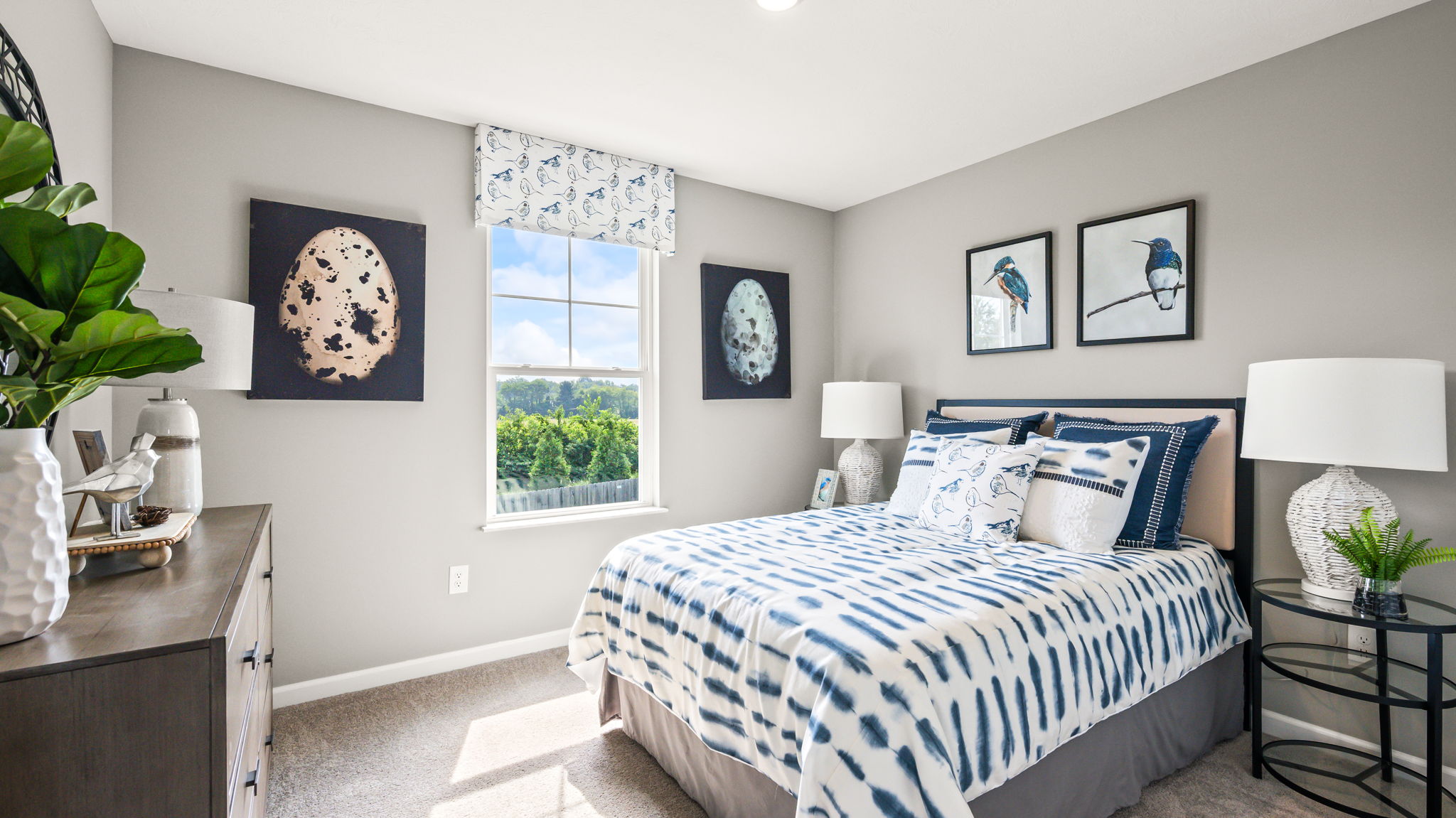 Carpeted upstairs hallway with open bedroom and bathroom doors, white trim, tiled bathroom entry, and a dresser visible in a bedroom.