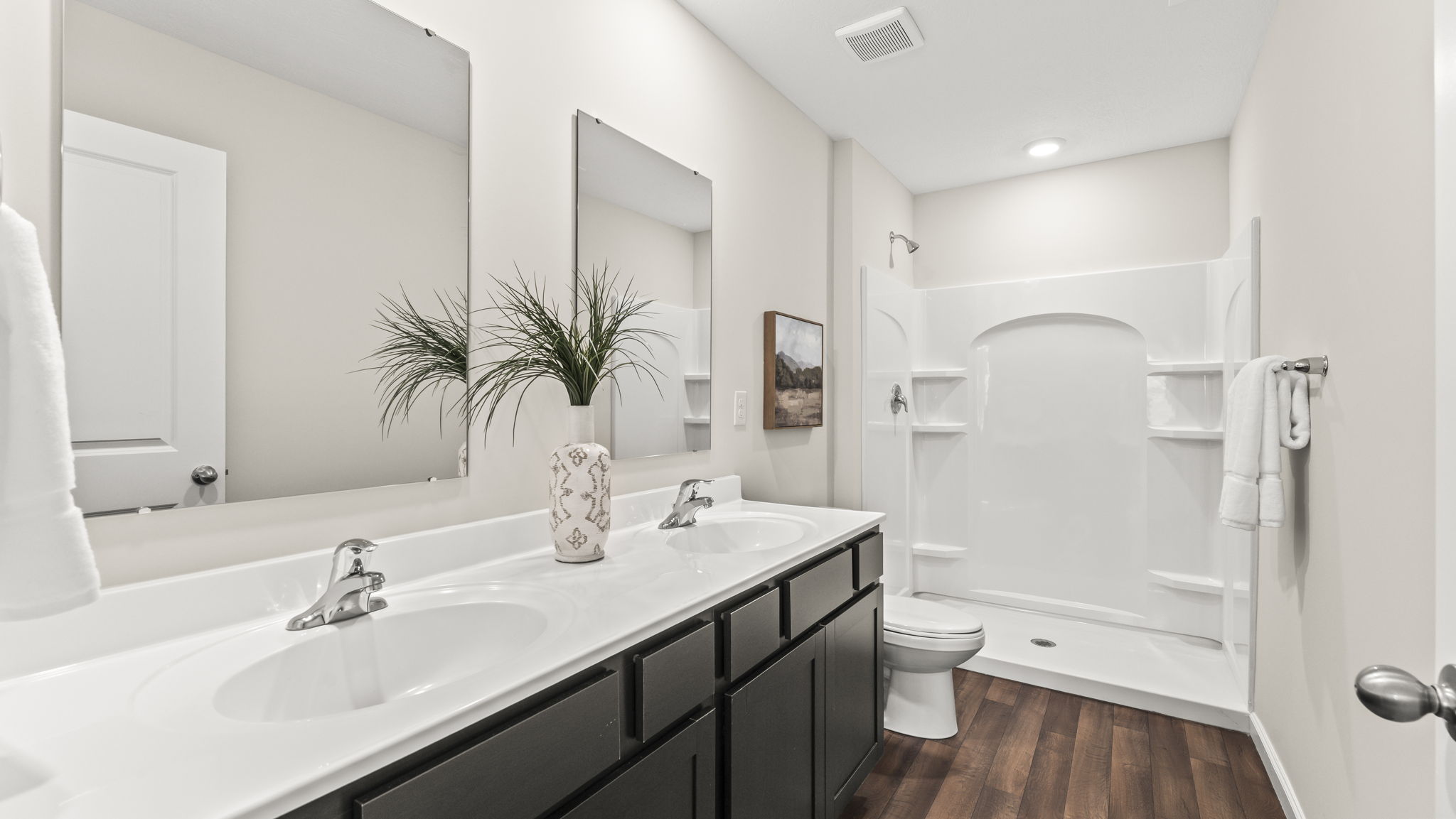 Owner’s ensuite adds stylish appeal, spa-inspired design, and access to the primary bedroom and walk-in closet