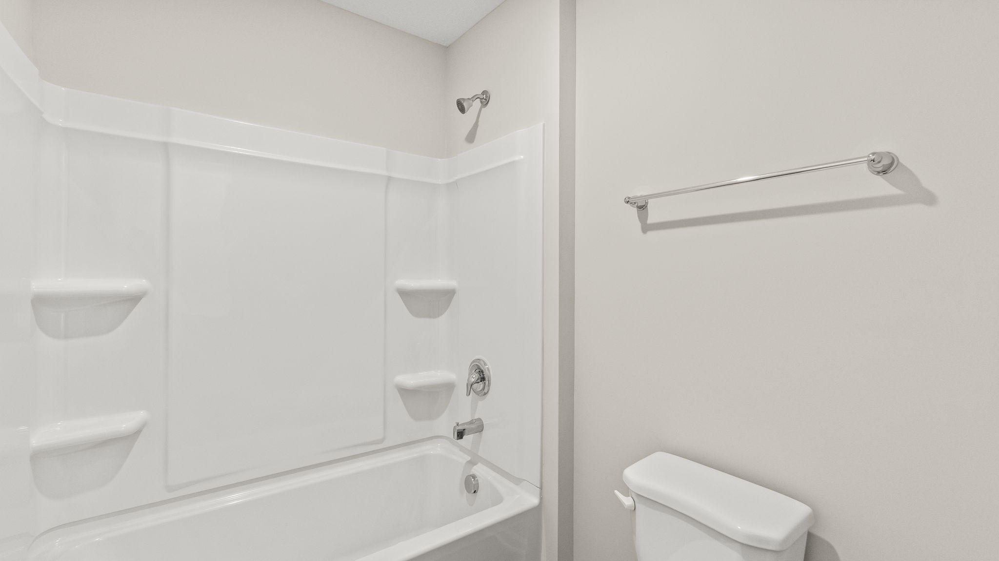 Closeup of shower with tub with tiered shelving