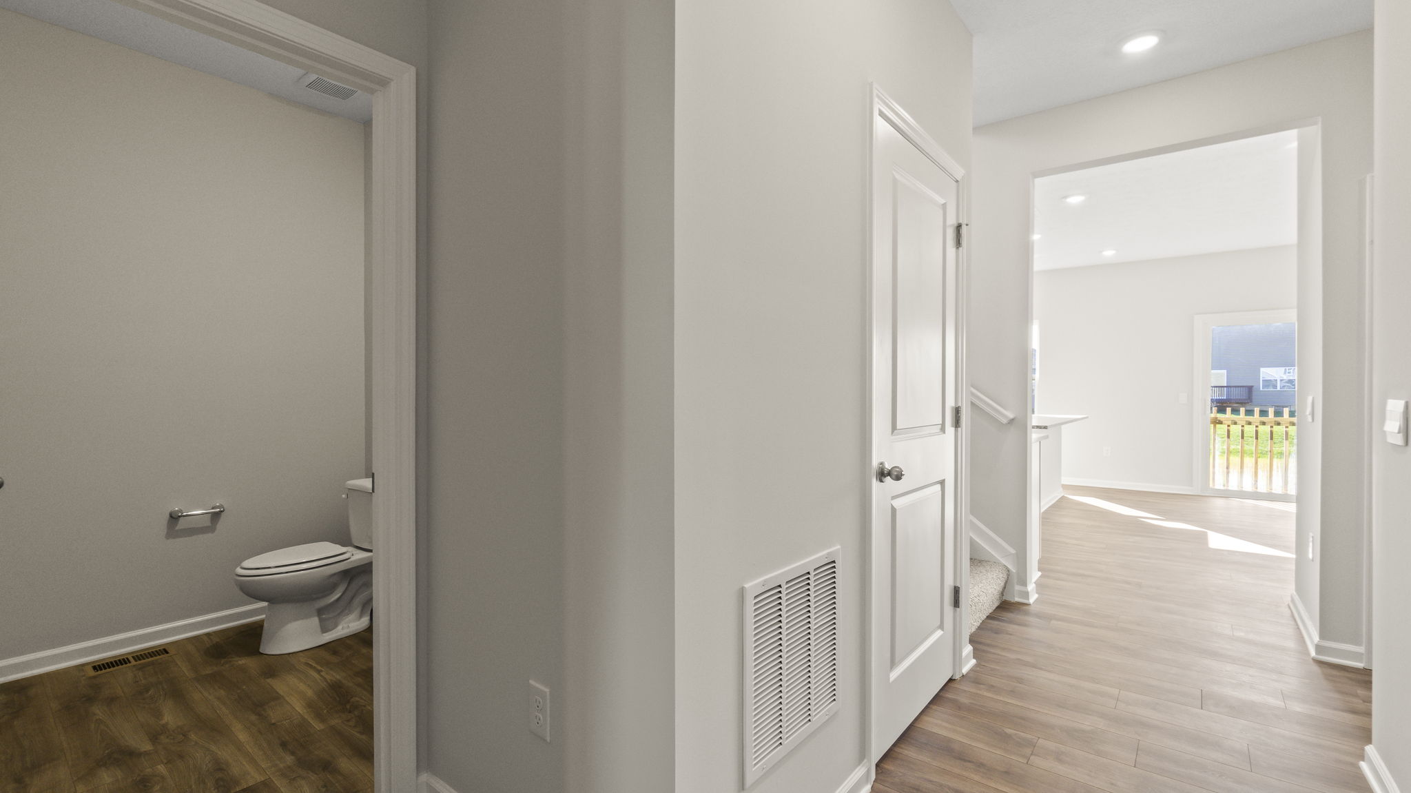 Hallway looking into bathroom ln the left and great area on the right