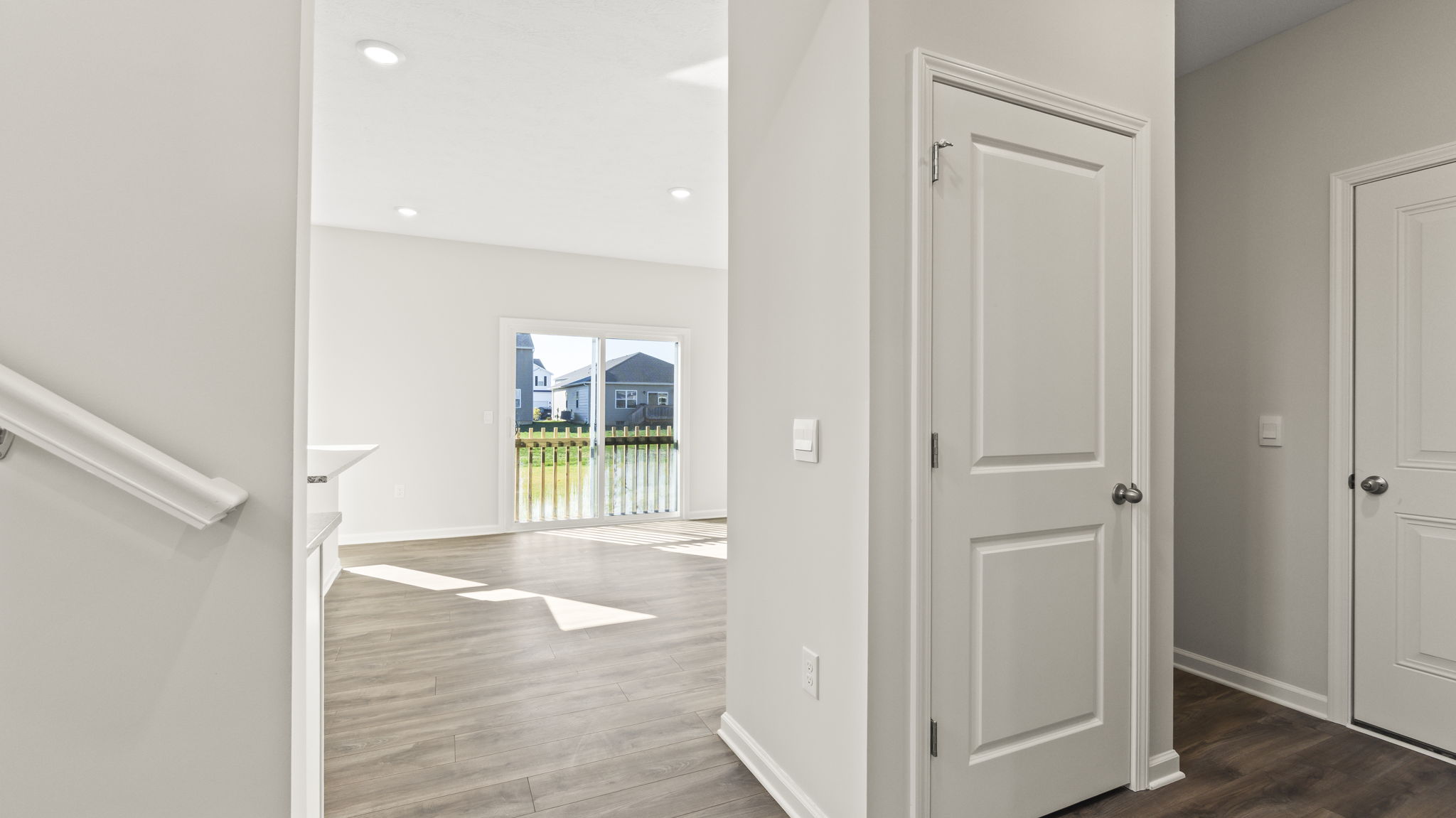 Hallway adjacent to stairs with closet space