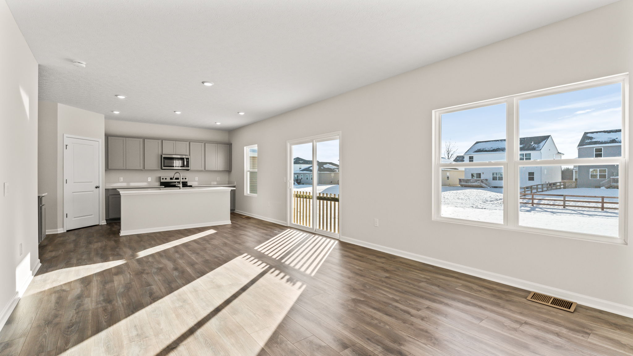 Full great room with two windows.