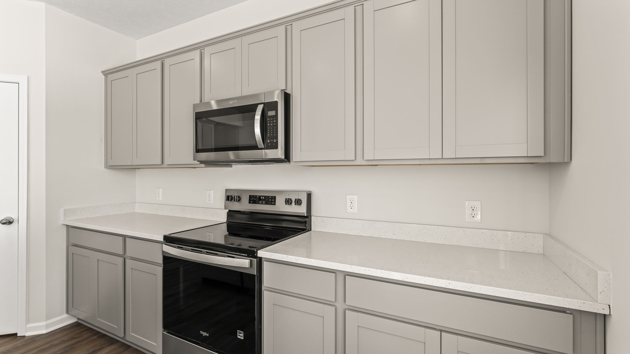 Closeup of kitchen countertops with appliances between cabinetry