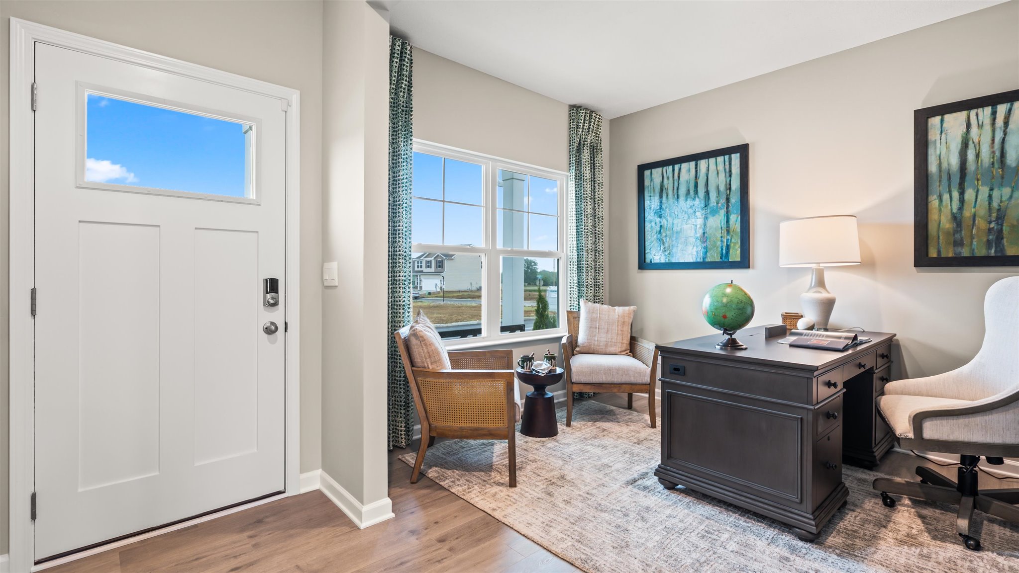 front door in foyer with view into the office.