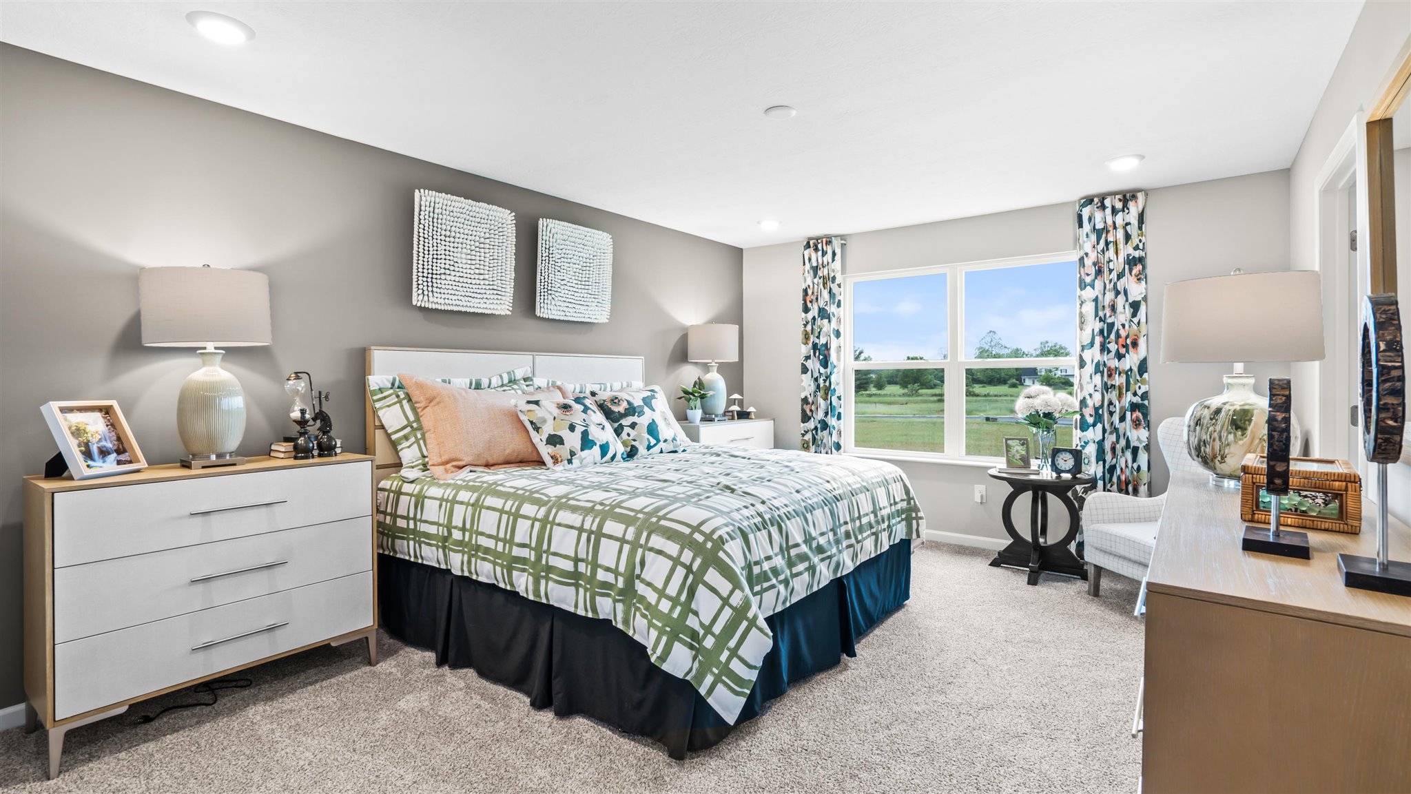 Primary Bedroom with large king bed, dual bedside tables with large drawers, and modern art décor.
