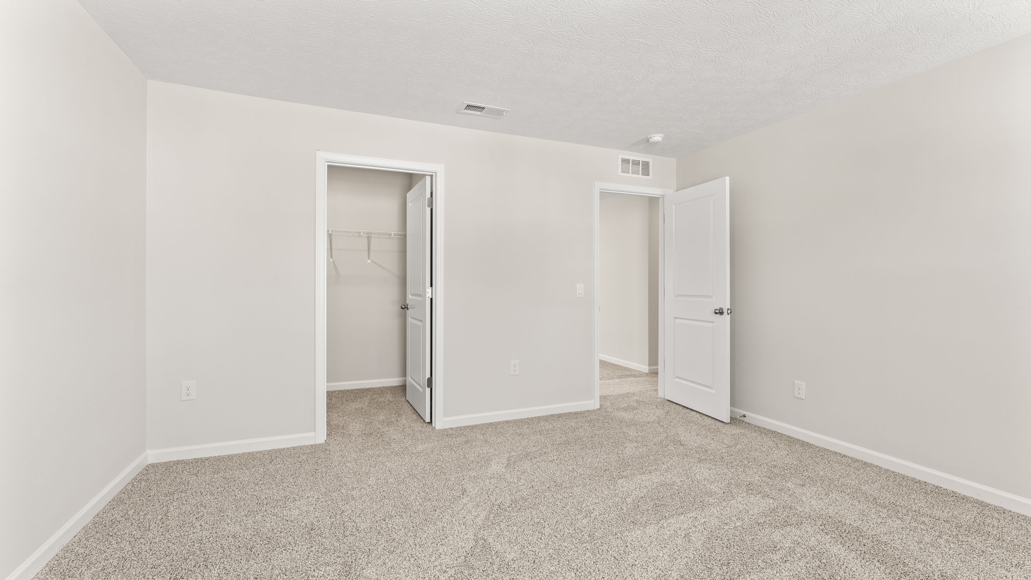 Bedroom with closet and door to hallway