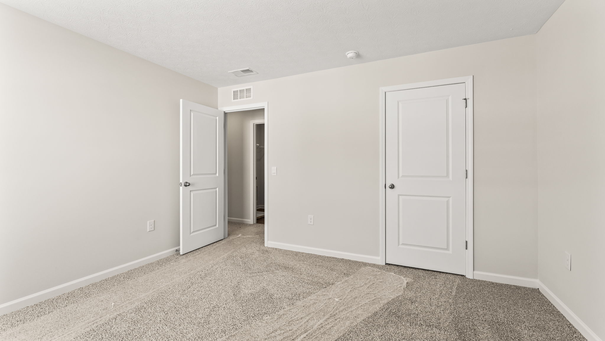 Bedroom with door to closet and hallway