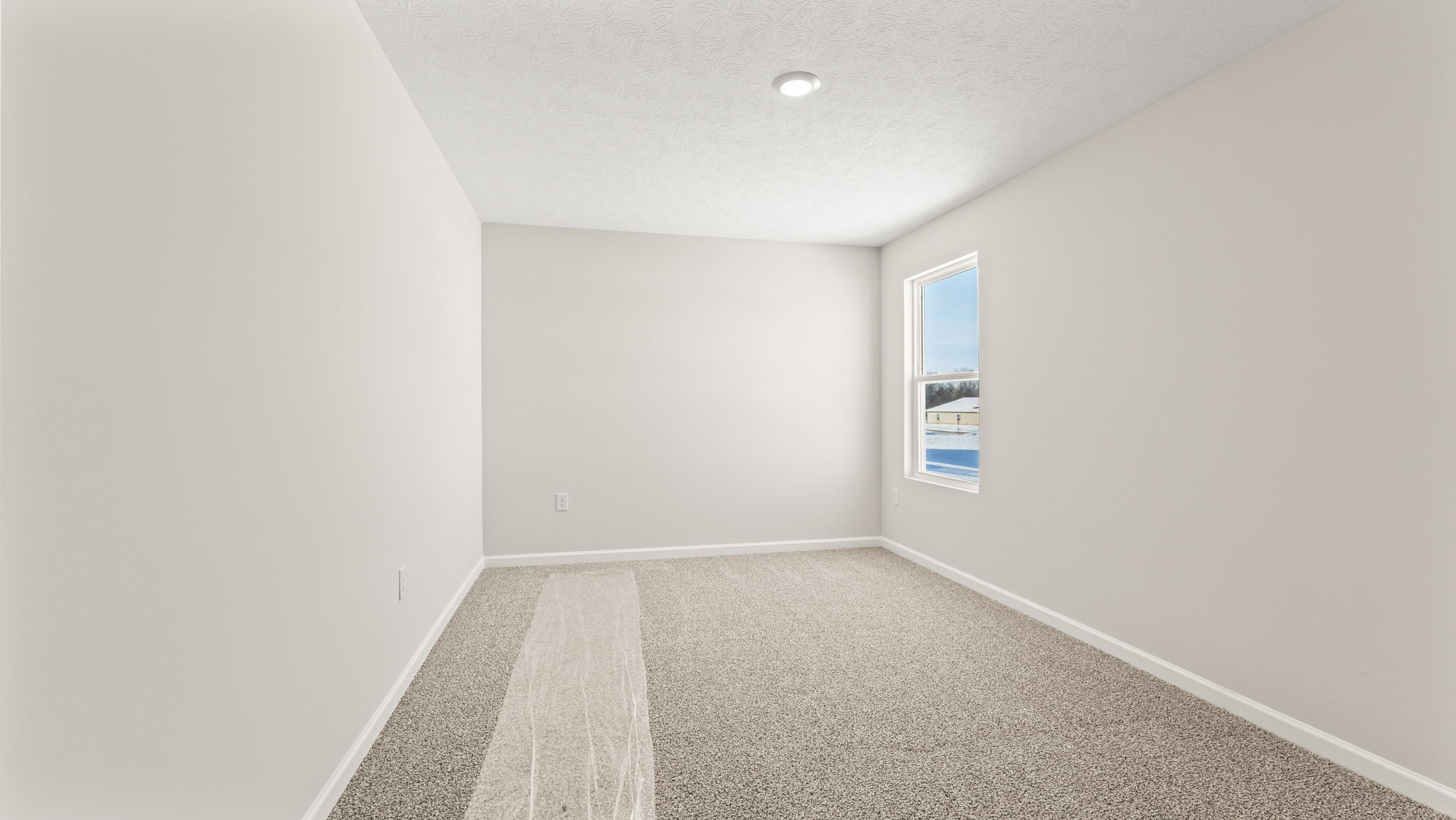 Carpeted bedroom with window