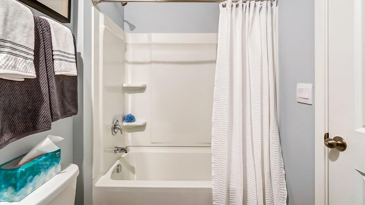 shower and tub combo in downstairs bathroom.