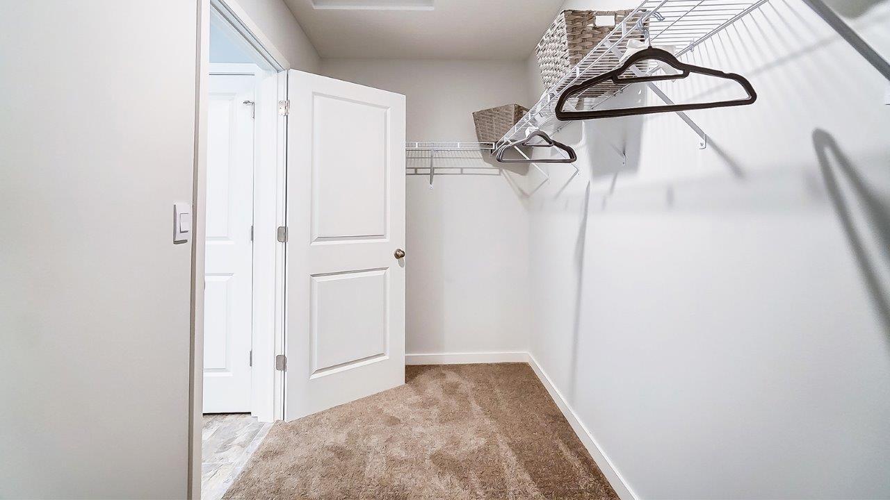 Walk-in closet with hangars.