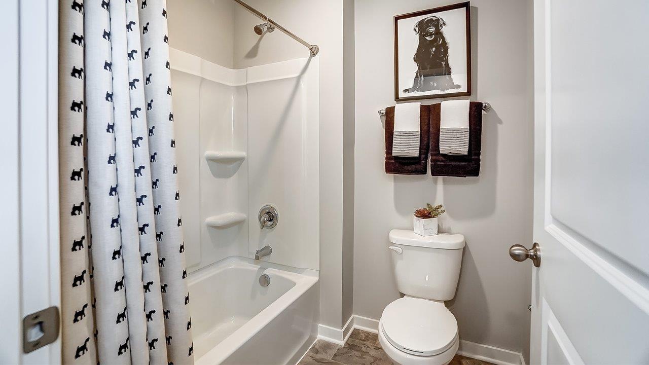 seperate shower and toilet area in shared bathroom.