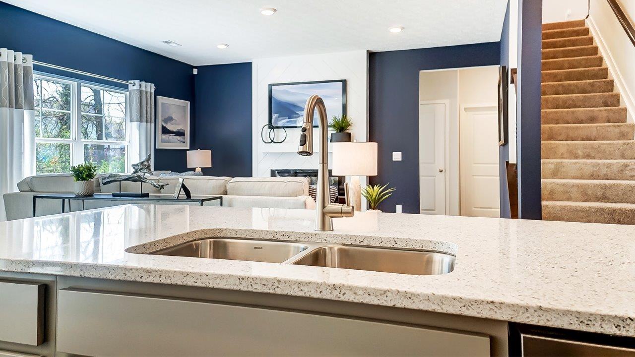kitchen island sink with great room in background