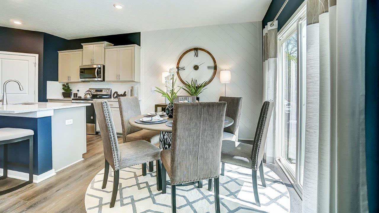 dining room with large grey chairs and beautiful clock