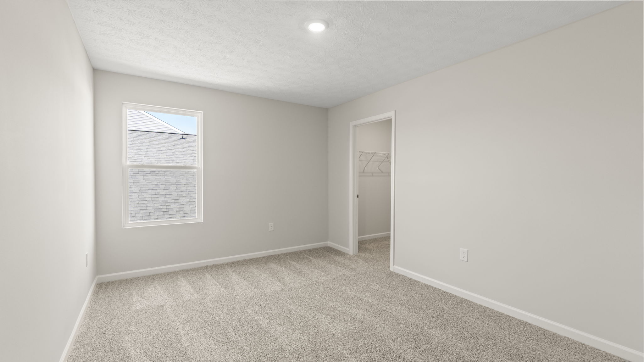 Bedroom with window and walk-in closet