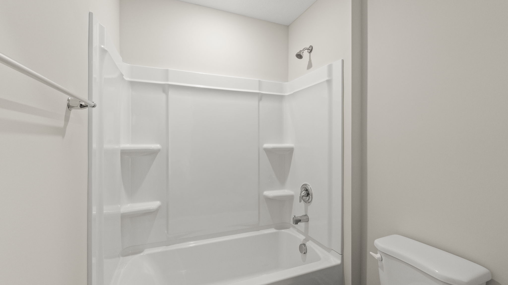Closeup of tub and shower with tiered shelving.