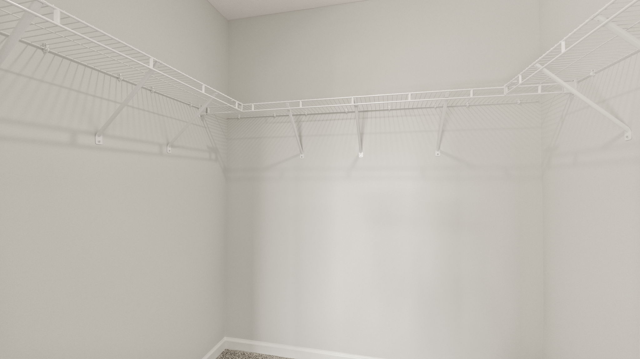 Walk-in closet with wire shelving.