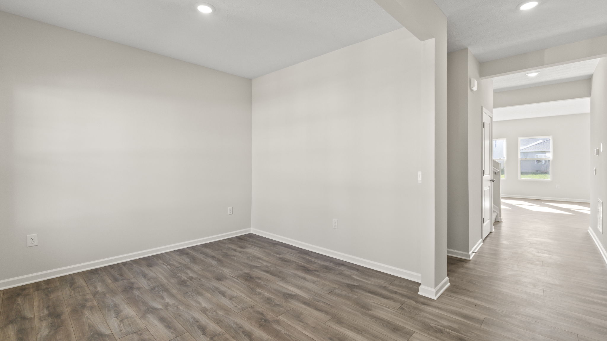 Hallway at front of the home looking into flext room