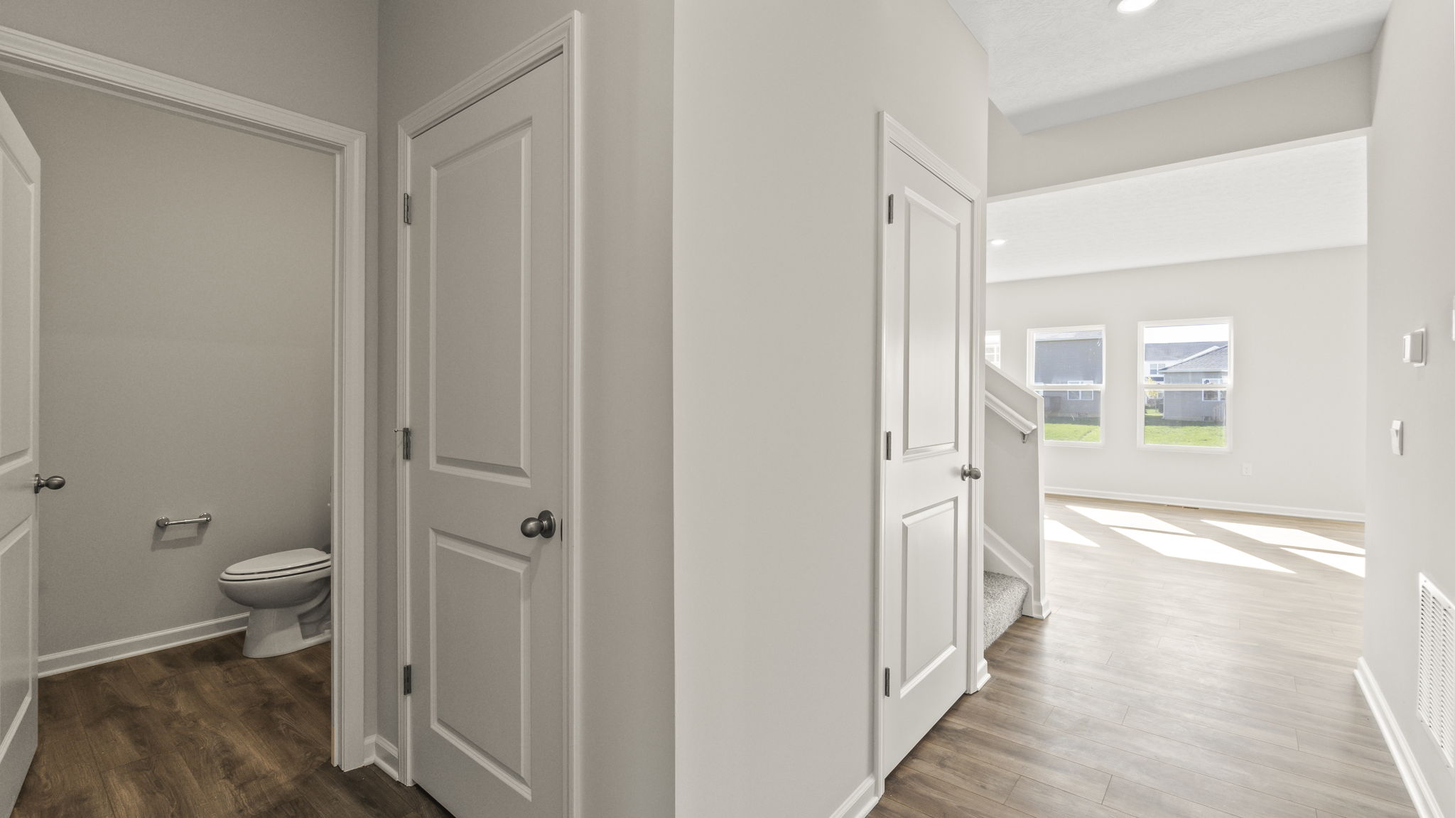 Hallway looking into bathroom ln the left and great area on the right