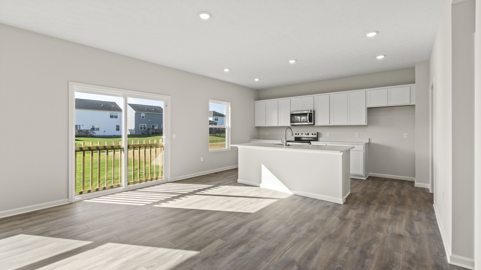 Full kitchen and living room with sliding door to the backyard.