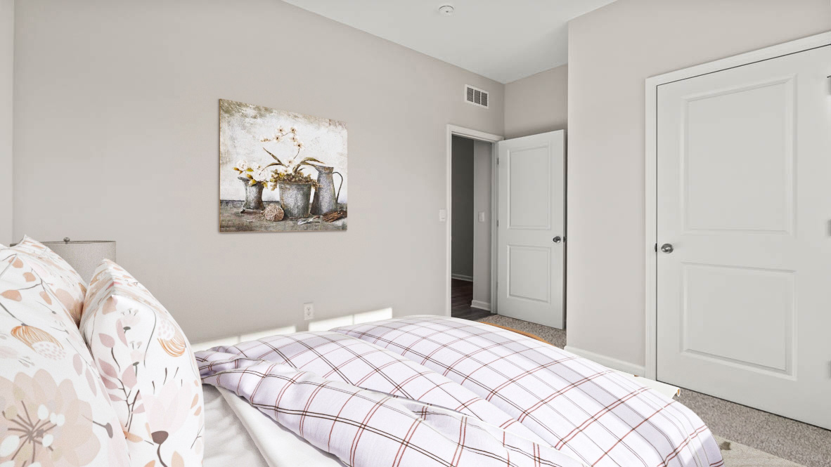 Front bedroom with large bed and decorative art.