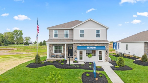 Front exterior of model home with partial brick siding.