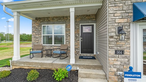 Front covered porch with brick siding.
