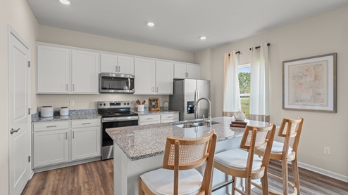 Kitchen with large island and granite countertops.