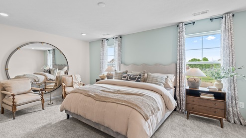 Primary bedroom with carpeted floors.