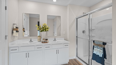 Primary bathroom with dual vanity sinks.