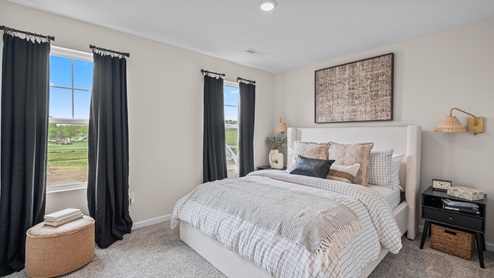 Bedroom with two windows for natural lighting.