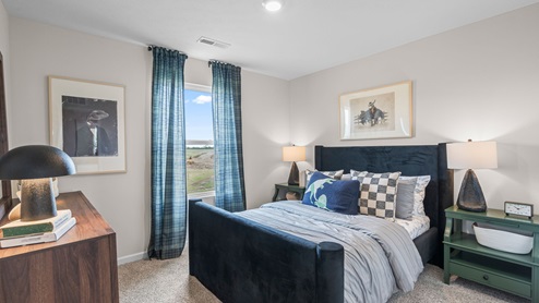 Bedroom with single window for lighting.