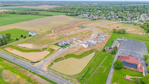 Aerial view of neighborhood with view of available homes.